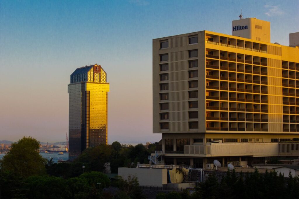 Capture of İstanbul's skyline with gleaming modern buildings at sunset.