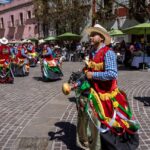 Colorful traditional dancers celebrating Mexican heritage in a lively town square.